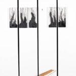 <strong>Whimsy in Black & Gray #2</strong><br />five small canvases mounted on four larger, acrylic on linen, one has fallen and rendered as Trompe L’oeil  48” X 120”<strong>SOLD</strong> Whimsy in Black & Gray #2